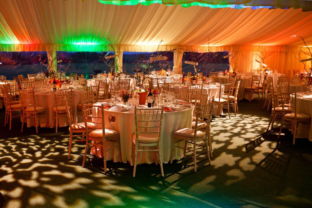 wedding marquee with tables chairs and lights