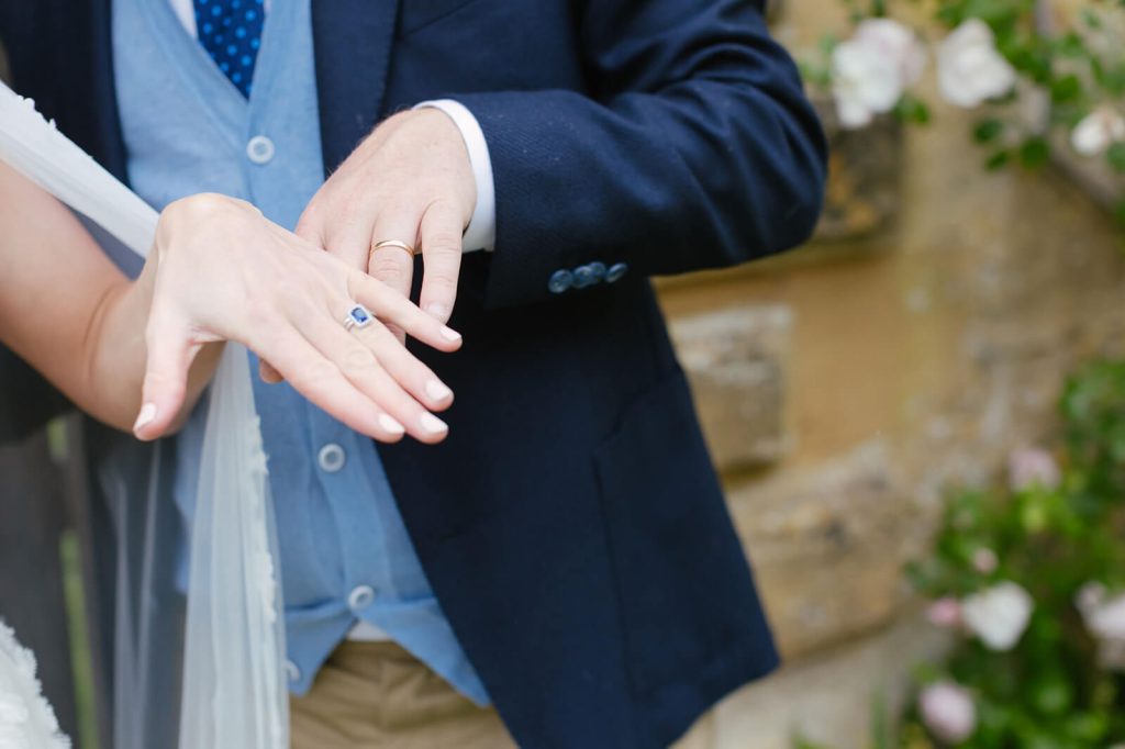 Wedding ring on show with bride and groom
