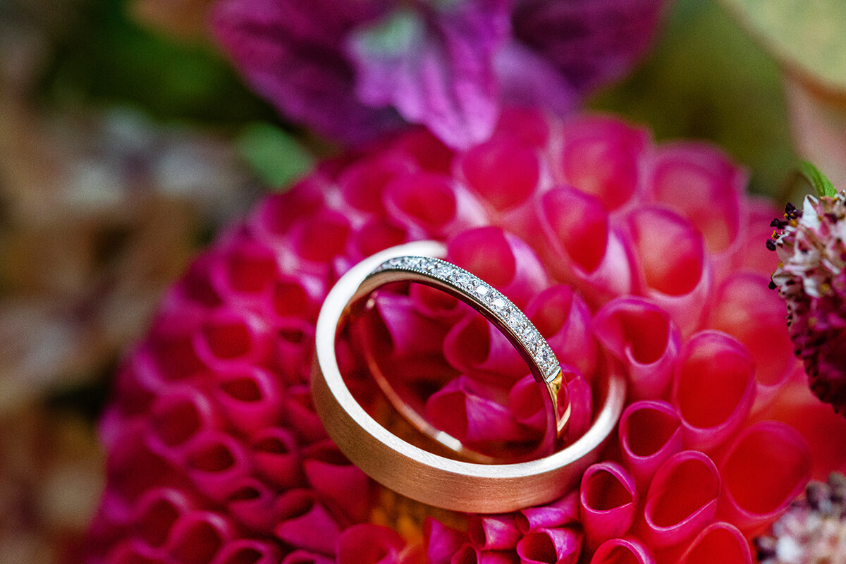 Wedding and Engagement ring on a dahlia