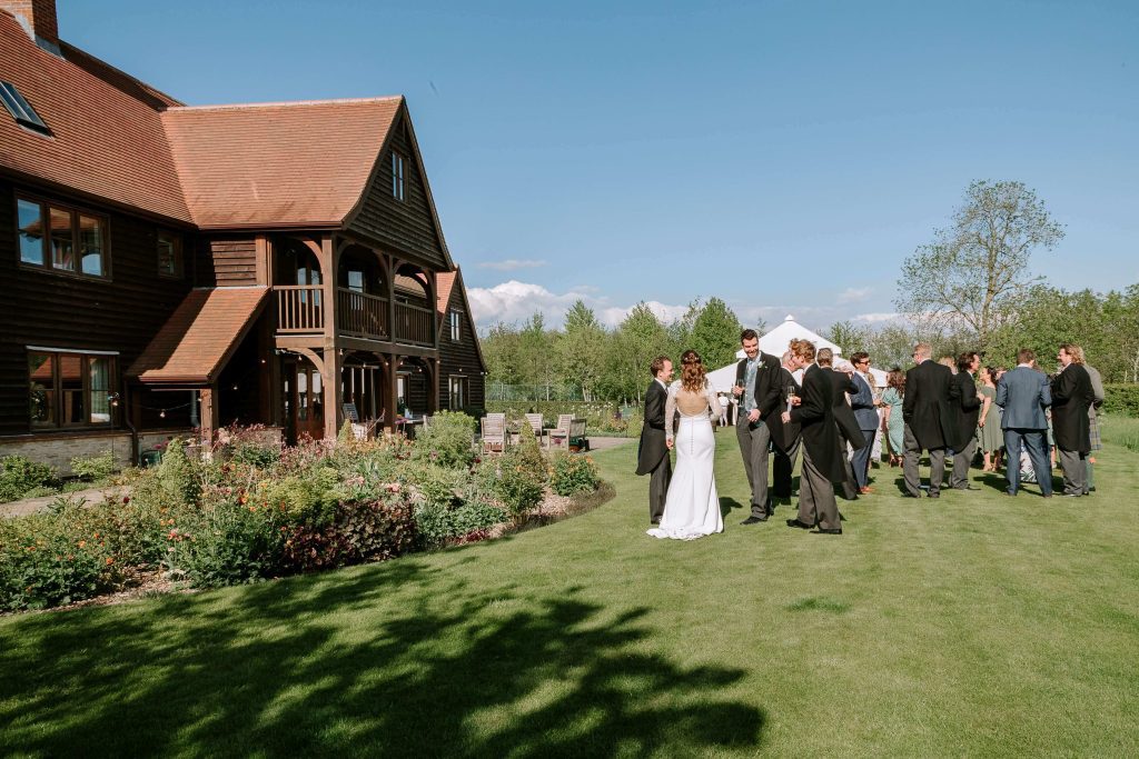 Bride and Groom talking to guest in their garden