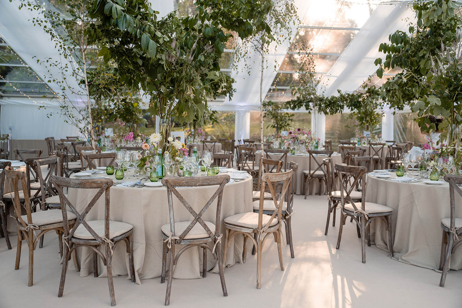 How to plan a marquee wedding with tables and chairs A pretty wedding breakfast set inside a clear span marquee.