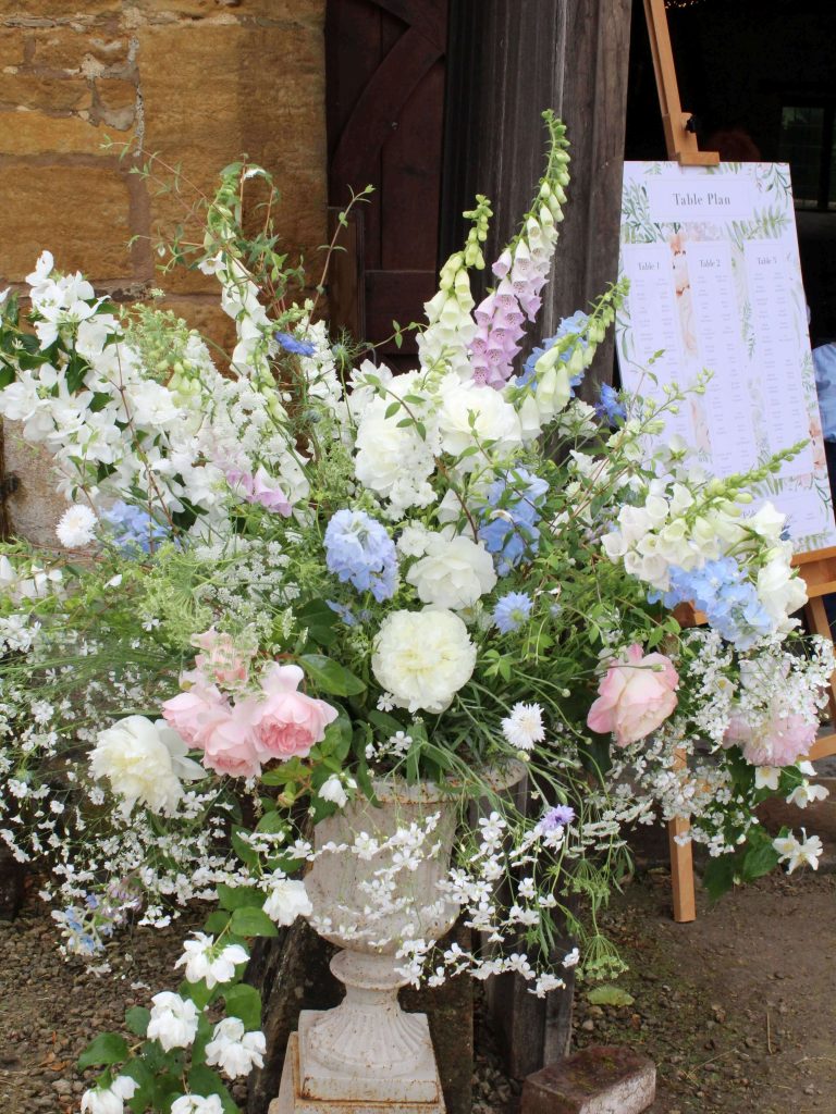 Pastel Coloured wedding flowers in urn