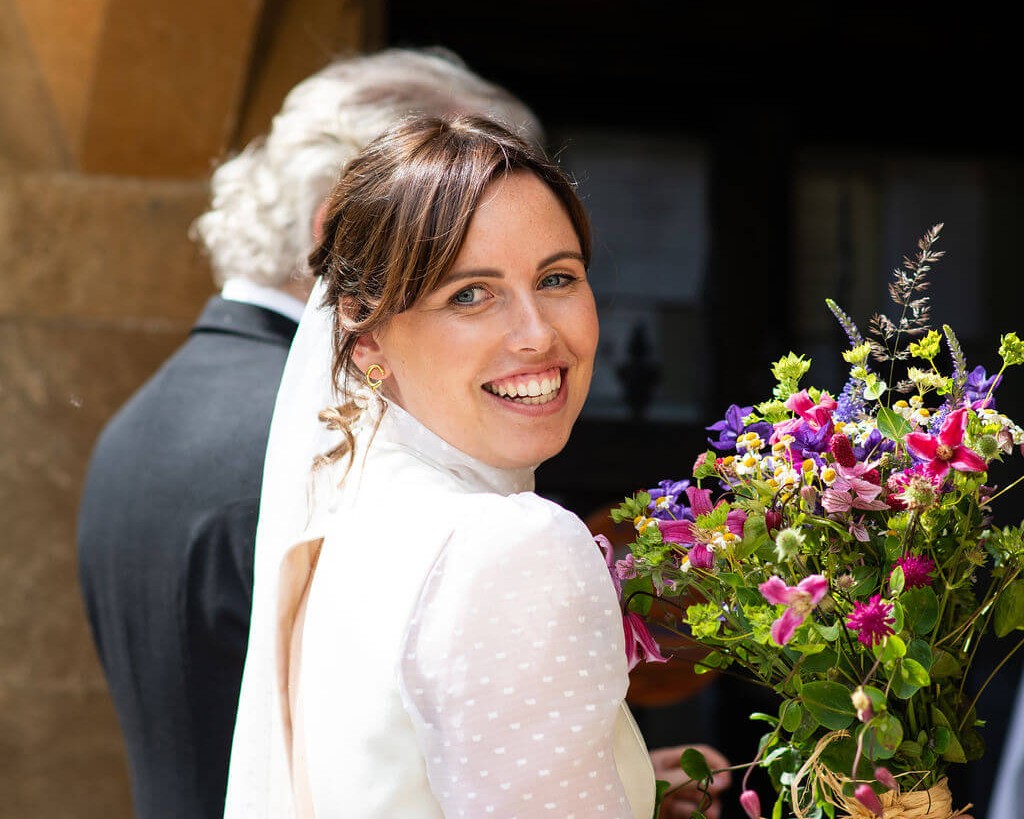 wedding colour scheme bride entering church with her father