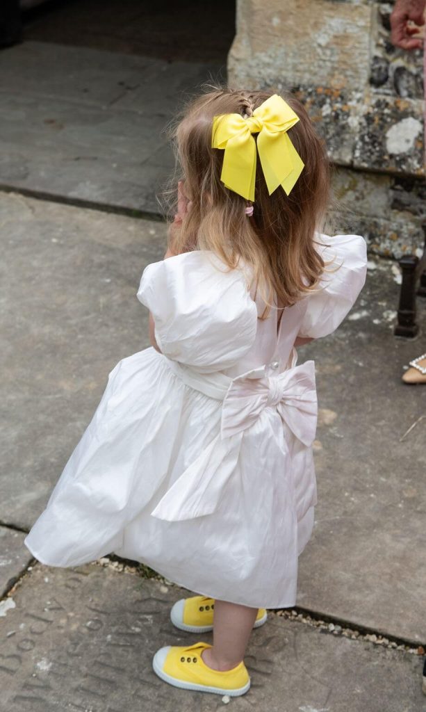 flower girl with yellow bow and sandles