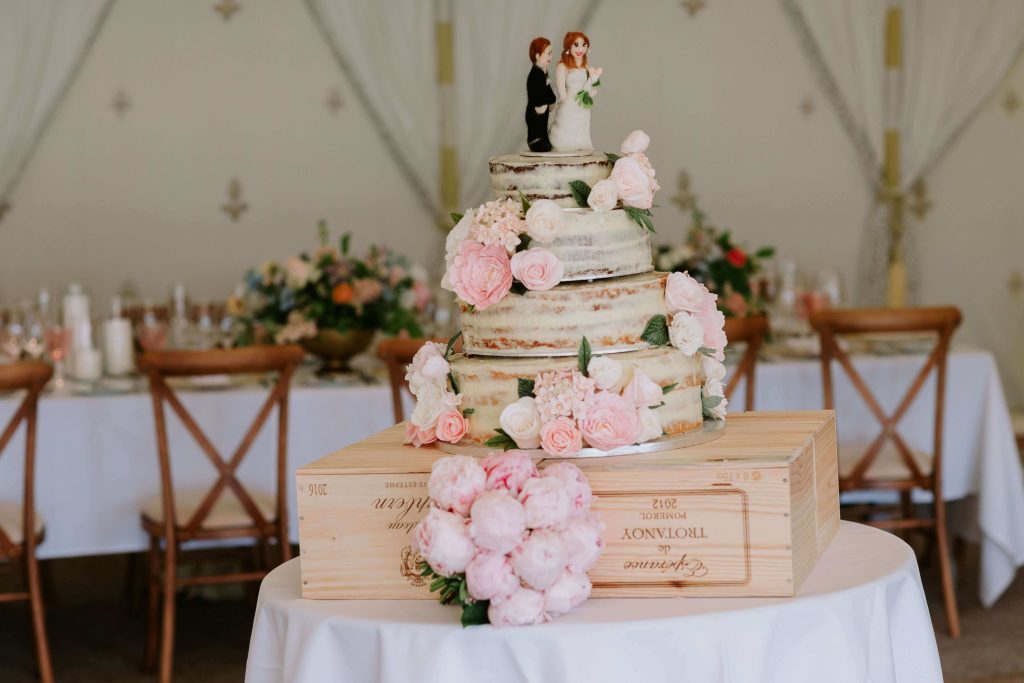 Semi naked wedding cake with pink flowers