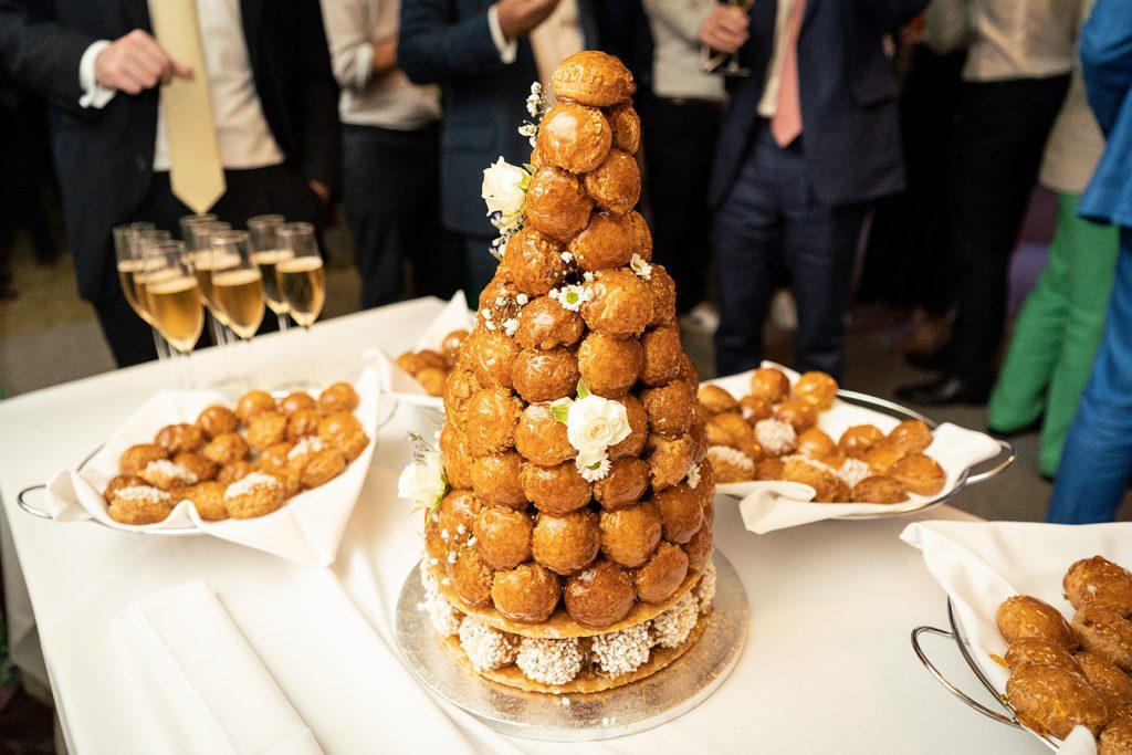 Traditional French croquembouche wedding cake surrounded by profiteroles and Champagne at Anglo-French wedding