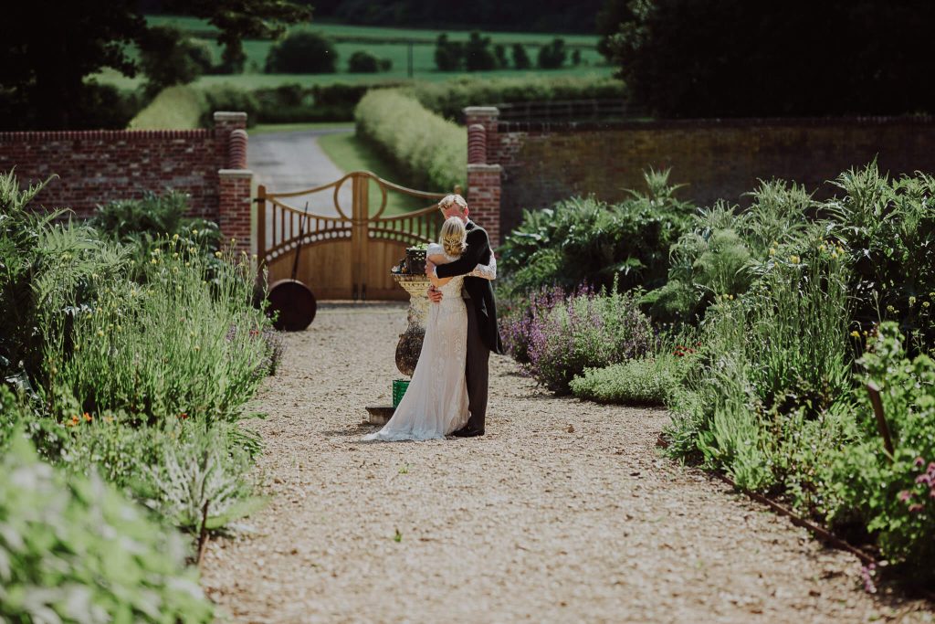 Wedding Venue Hungerford Bride Groom walking away from guests
