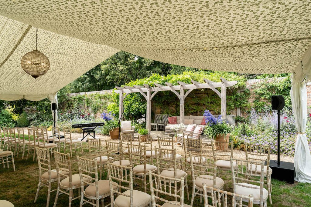 wedding ceremony set up in marquee for outdoor wedding in the uk