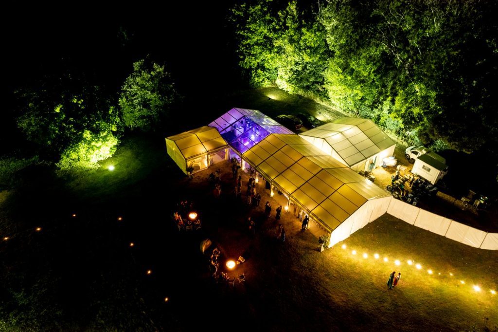 marquee wedding at night surrounded by trees