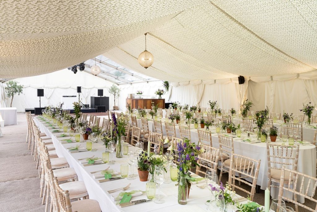 long tables with flowers for marquee wedding