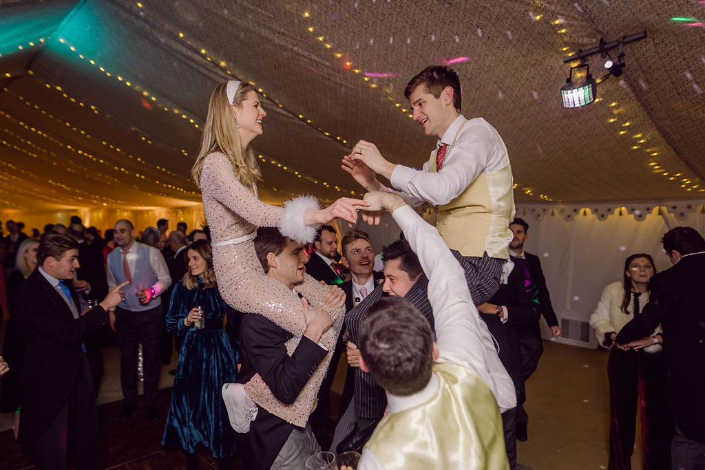 lively dancing on friends' shoulders at Welford Park wedding in Berkshire