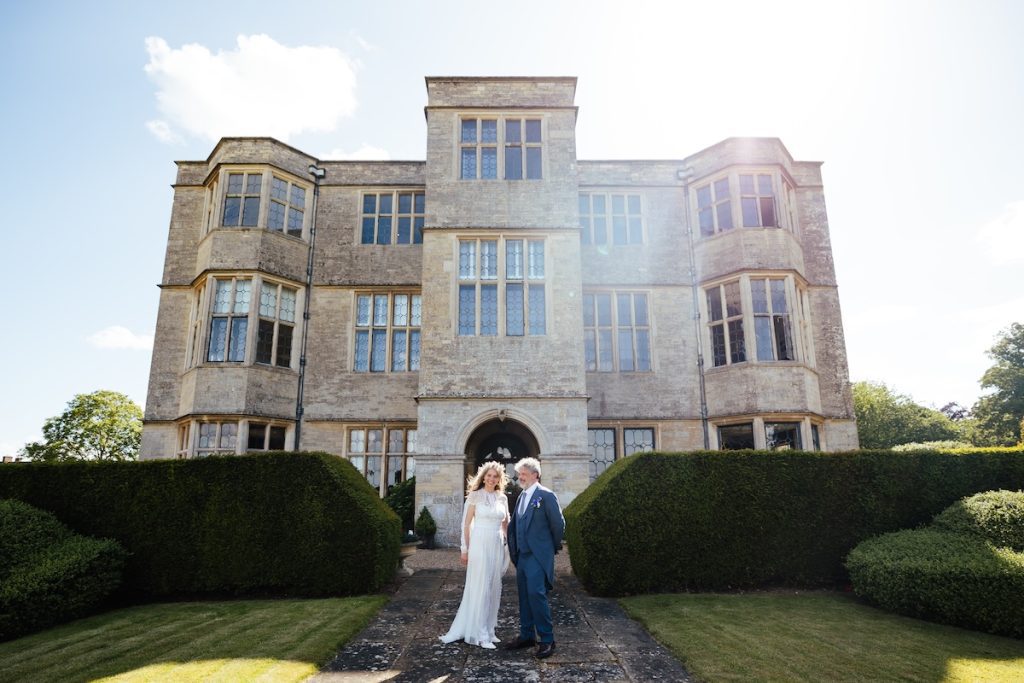 Bride and father standing in front of gayhurst court wedding venue