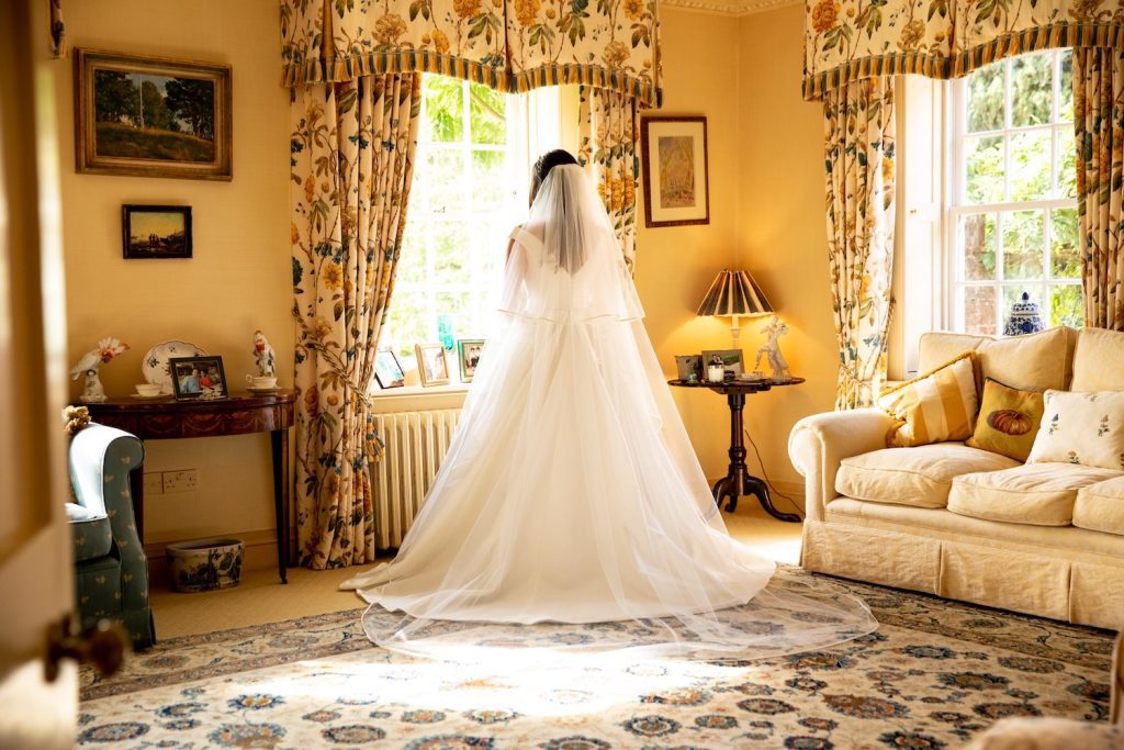 bride with cathedral veil getting ready for wiltshire wedding