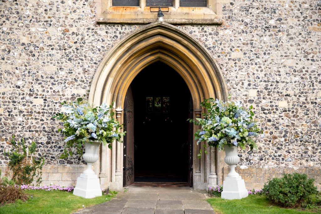 wiltshire church decorated with blue and white flowers for wedding