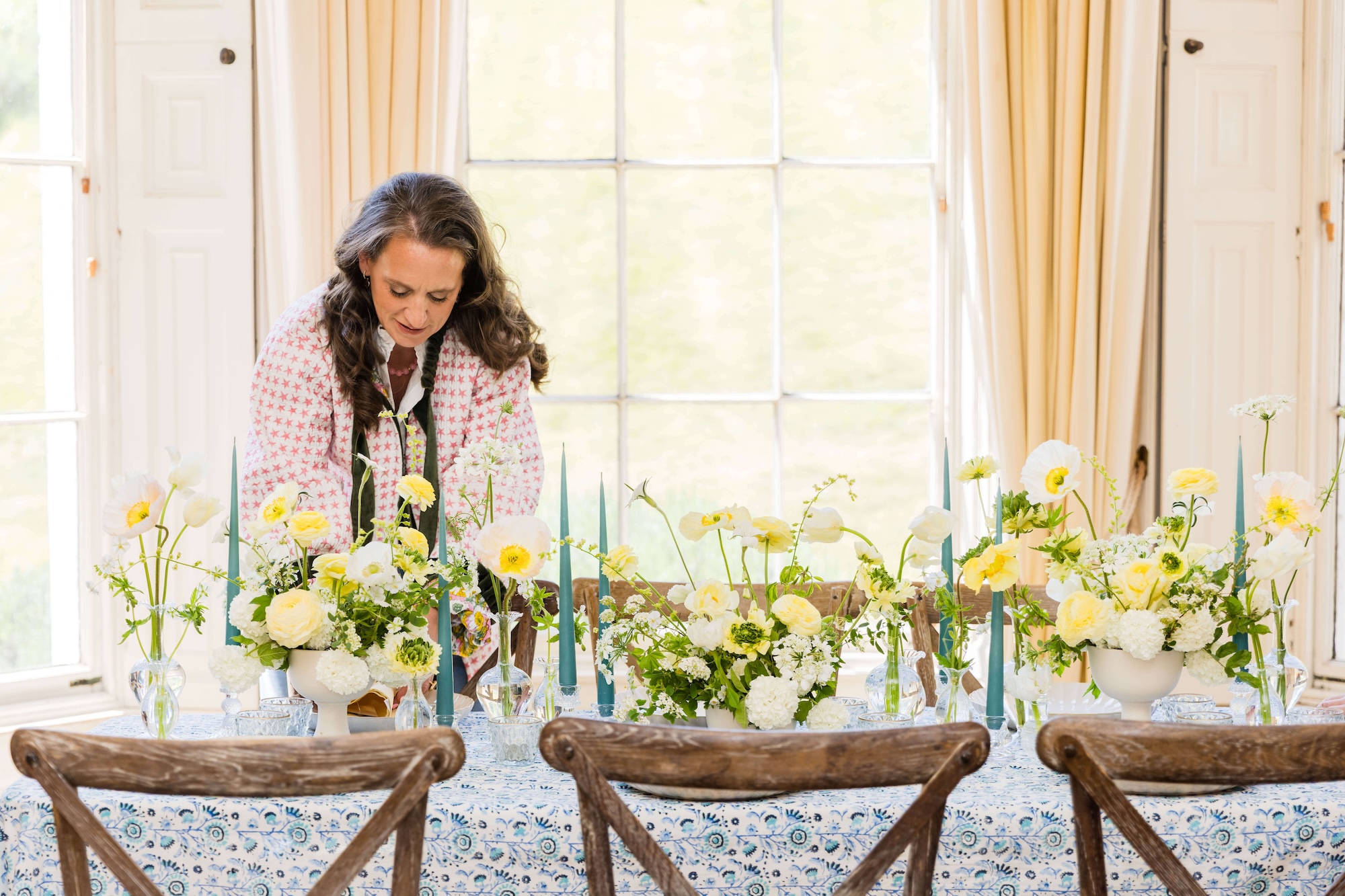 Antonia Roskill working on table setting Blue and yellow themed wedding breakfast styled by Honour and Pop